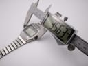 A digital caliper measuring the case diameter of the Seiko A229-5060, displaying a precise measurement of 35.63mm.