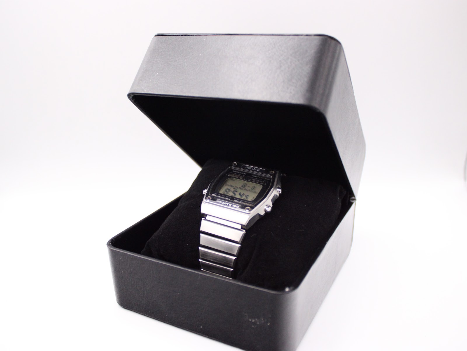 The Seiko A229-5060 watch presented within a black generic watch box on a white background.