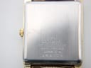 Close-up of the brushed stainless steel case back of the Seiko watch, showing model 6530-5430 and serial number 4N4379 engravings.