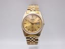 Front view of the gold-tone Seiko 5Y23-8A60 watch with a gold sunburst dial, fluted bezel, and jubilee bracelet.