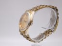 Side view of the Seiko watch, showing the fluted bezel and gold-tone case, with some wear visible.
