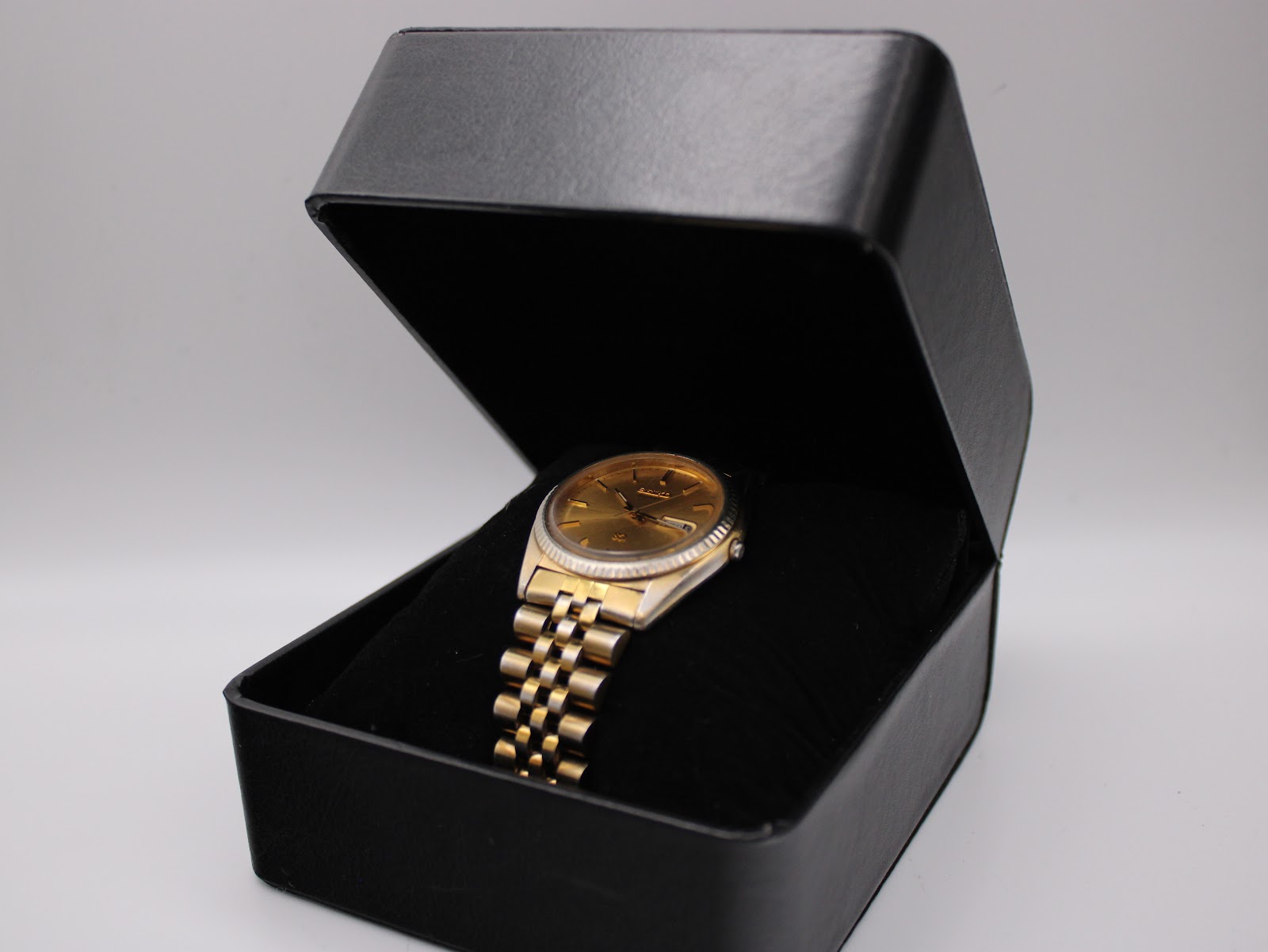 The Seiko watch displayed inside a generic black presentation box.