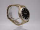Another angled view of the Seiko watch on a clear stand, highlighting the dial and bracelet flow.