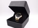 The gold tone Seiko watch presented inside a generic open black display box.