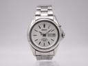 Front view of the Seiko Kinetic 5M63-0B90 watch with silver dial, baton indices, and day-date display.