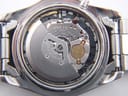 Close-up view of the Seiko Kinetic 5M63A movement inside the open case, showing "KINETIC", "JAPAN", and "SIX 6 JEWELS" engravings.