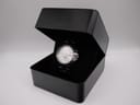 The Seiko Kinetic watch presented within an open black display box, highlighting its overall appearance.