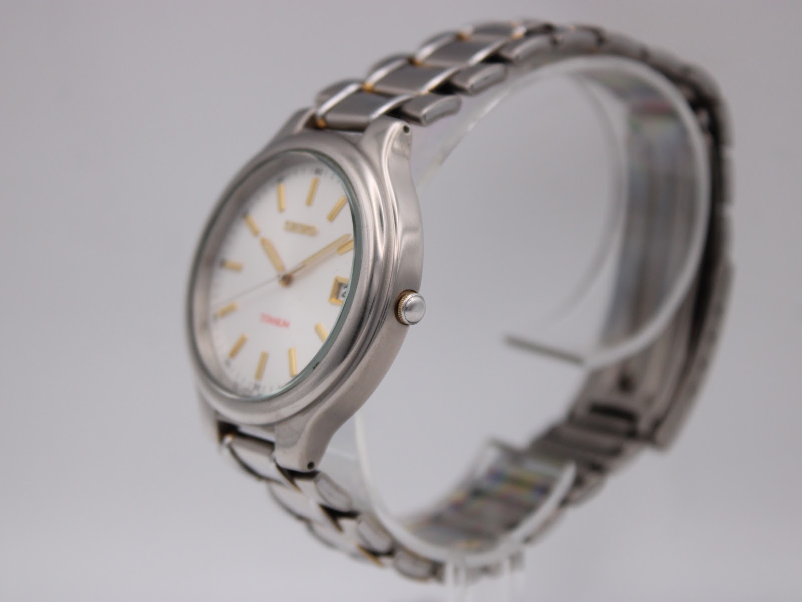 Side profile view of the Seiko titanium watch showing the subtle curve of the case and integrated bracelet.