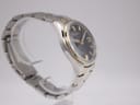 Another angled side view of the Seiko watch, focusing on the profile of the case and the gold-tone bezel.