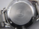 Close-up of stainless steel case back with Seiko branding, 5 bar water resistance, model number 5M42-0070, and serial number.