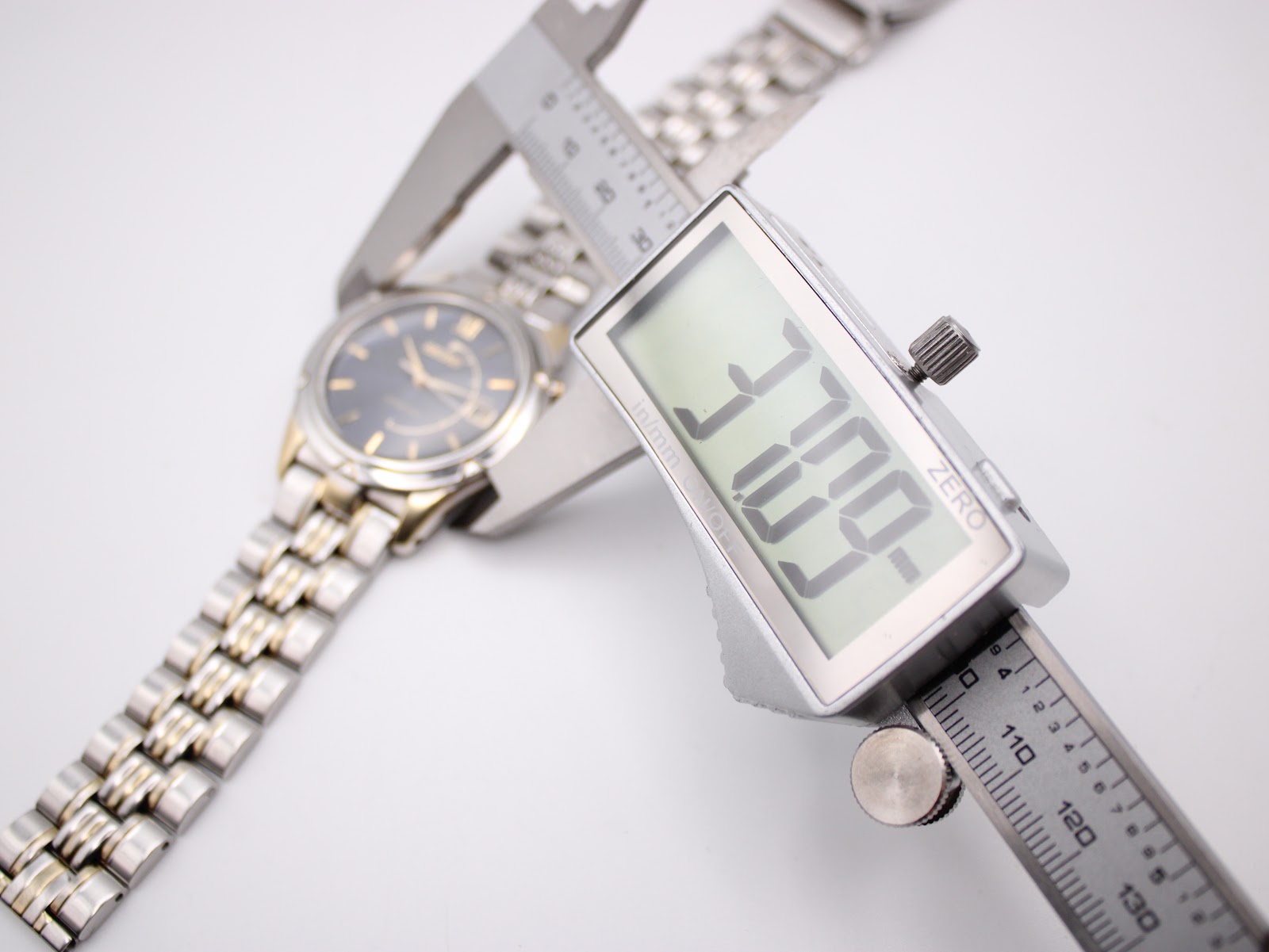 Top-down view of the watch being measured by a digital caliper, displaying a case diameter of 37.09mm.