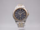 Front view of the Seiko Kinetic 5M22-7B30 watch with navy dial, gold-tone bezel and two-tone steel bracelet.