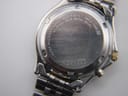 Close-up of the watch case back engraved with "SEIKO", "5M22-7B30", "WATER RESISTANT 10 BAR", and serial number "455887".
