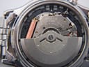 Macro shot of the Seiko 5M22A Kinetic movement inside the watch, showing the rotor and coil.