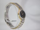Opposite angled side view of the Seiko Creo watch, highlighting the two-tone bracelet design on a clear display stand.