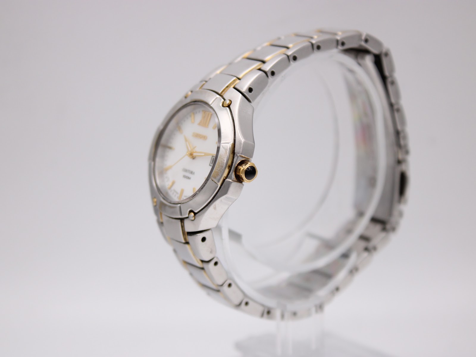 Side view of the Seiko Coutura watch showcasing the two-tone case and integrated bracelet.