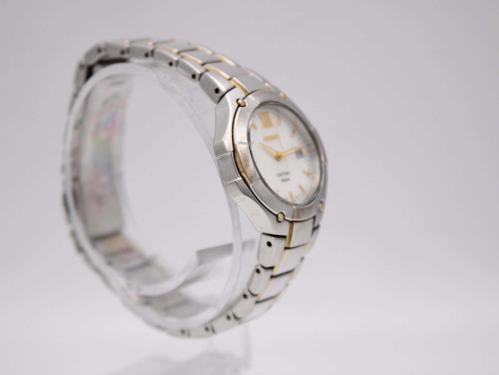 Another side view of the Seiko Coutura watch on a display stand, highlighting the bracelet design.