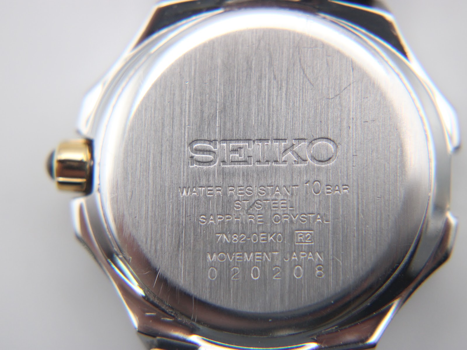 Close-up of the brushed stainless steel case back with Seiko branding and model details.