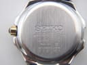 Close-up of the brushed stainless steel case back with Seiko branding and model details.