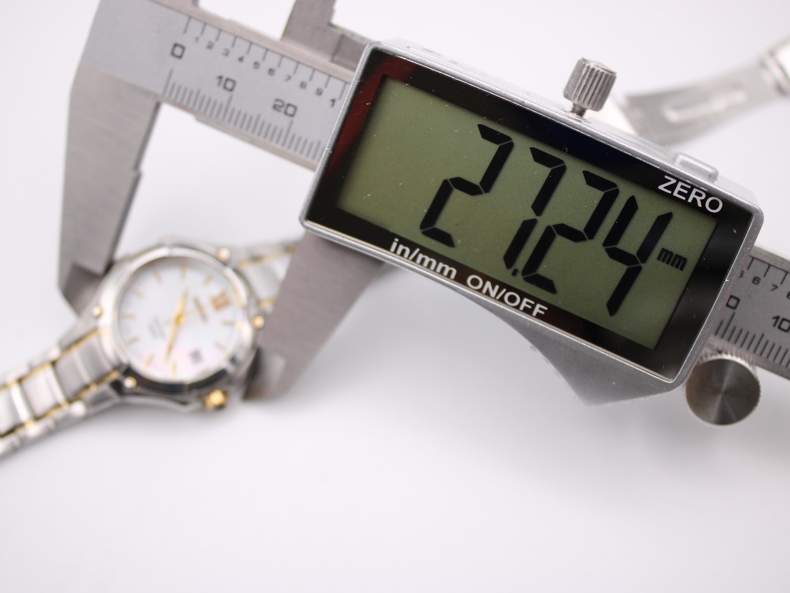 Digital caliper showing the precise case diameter measurement of the Seiko Coutura watch at 27.24mm.