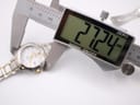 Digital caliper showing the precise case diameter measurement of the Seiko Coutura watch at 27.24mm.