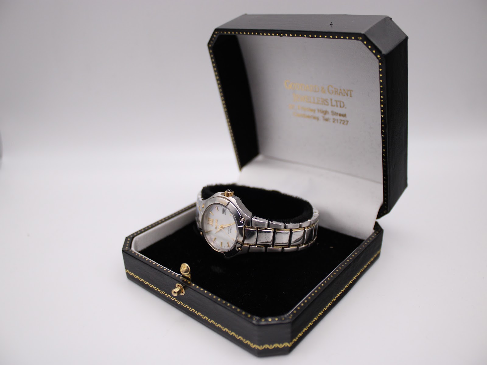 Seiko Coutura watch displayed in an open black and gold-trimmed gift box.