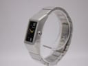 Angled front-right view of the Seiko watch on a display stand, showcasing the polished stainless steel case and crown.