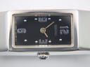 Close-up of the watch dial, showing the applied silver numbers 12, 3, 6, 9, and dot indices on a black background.