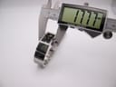 Digital caliper measuring the case width of the watch, displaying a precise measurement of 17.77mm.