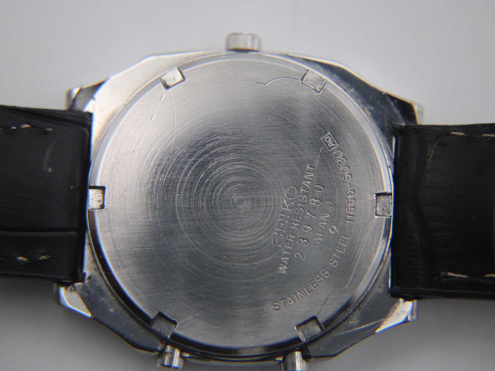 Close-up of the stainless steel case back of the Seiko H556-5030, showing model and serial numbers.