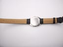 Rear view of the Seiko H556-5030 watch with black leather strap laid flat, showing case back and strap interior.