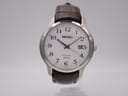 Front view of Seiko 7N42-0GE0 quartz watch with white dial, black Arabic numerals, and a brown leather strap.