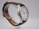 Angled side view of the Seiko watch, highlighting the case profile and the texture of the brown leather strap.