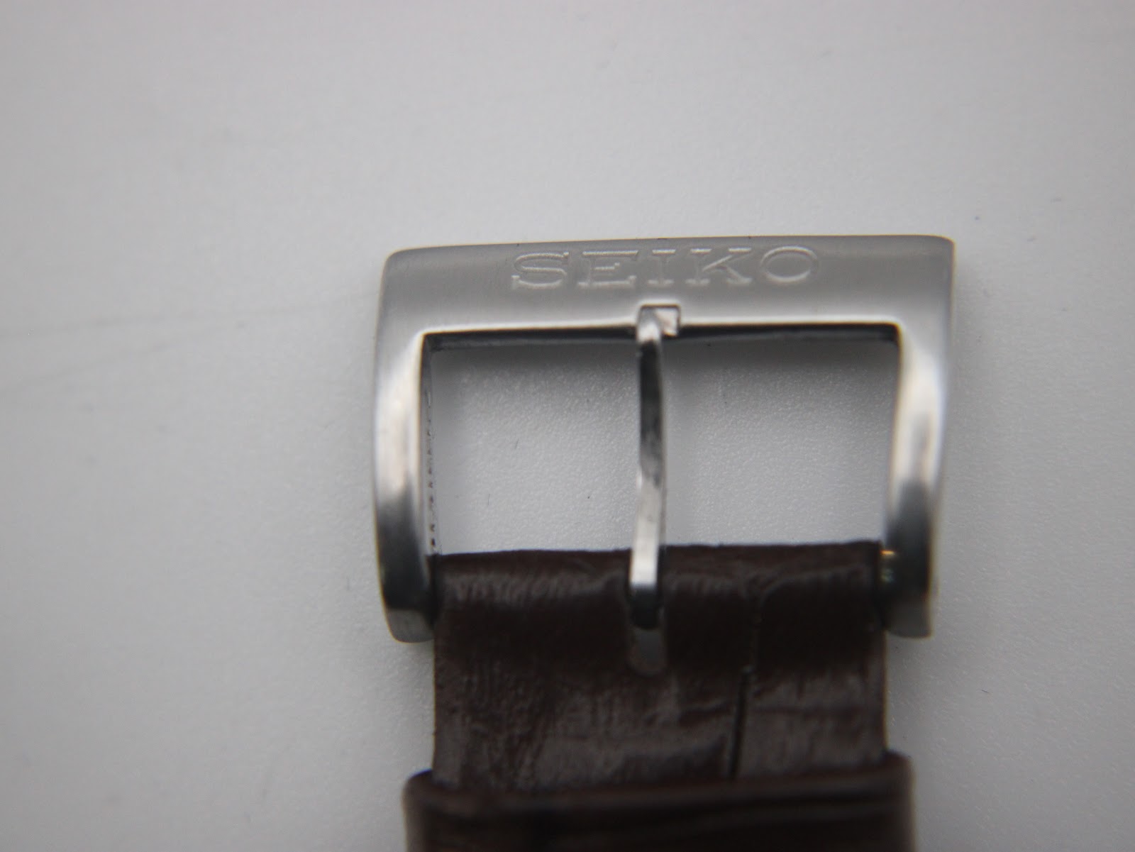 Close-up of the stainless steel buckle, clearly showing the 'SEIKO' brand engraving.