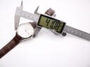 Digital caliper measuring the watch case diameter at 41.08mm, with the Seiko watch visible in the background.