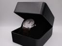 The Seiko watch nestled inside a generic black presentation box.