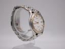 Angled right side view of the Seiko watch, highlighting the gold-tone crown and integrated bracelet design.