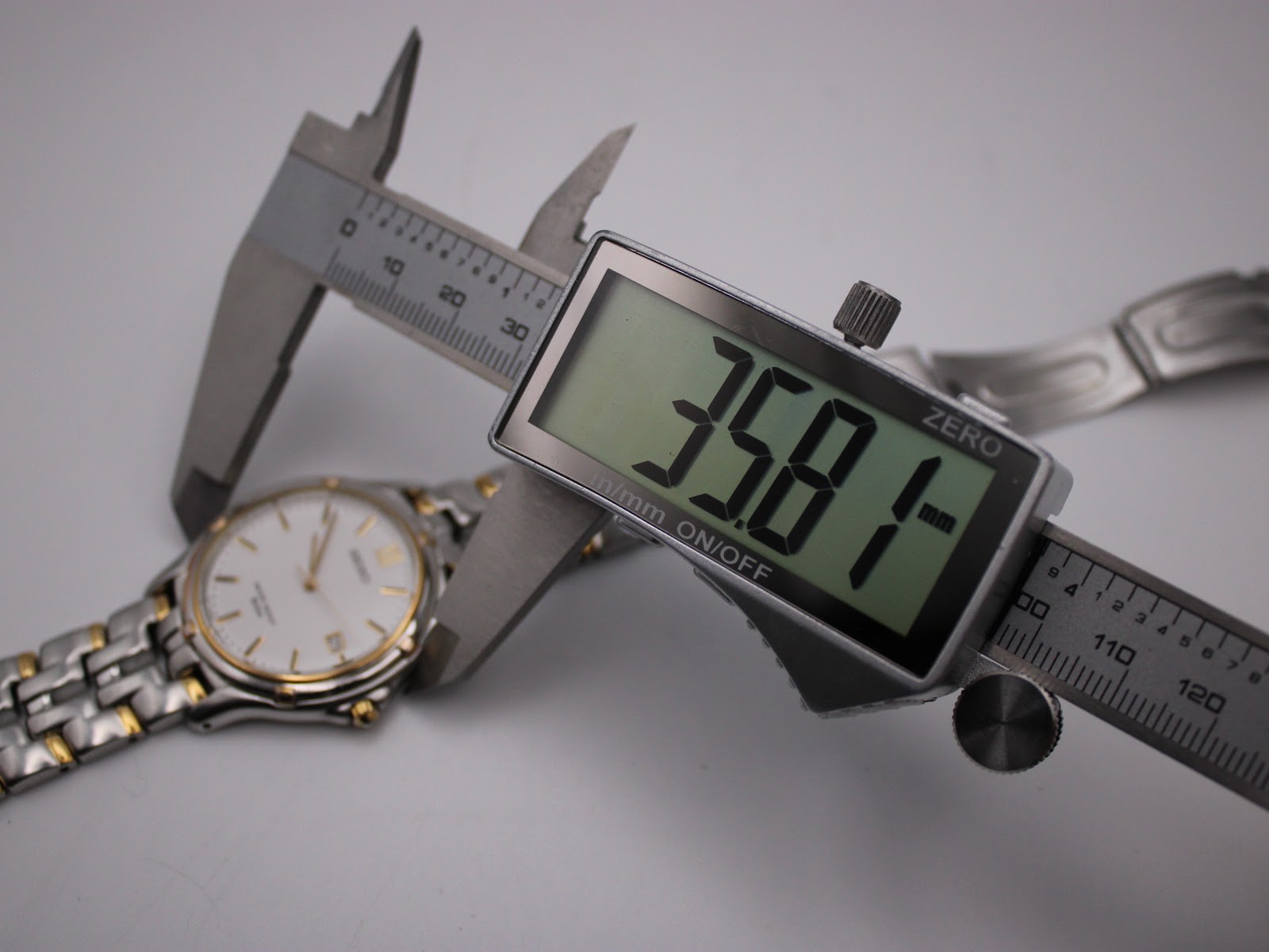 Digital caliper measuring the watch case diameter at 35.81mm.