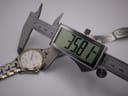 Digital caliper measuring the watch case diameter at 35.81mm.
