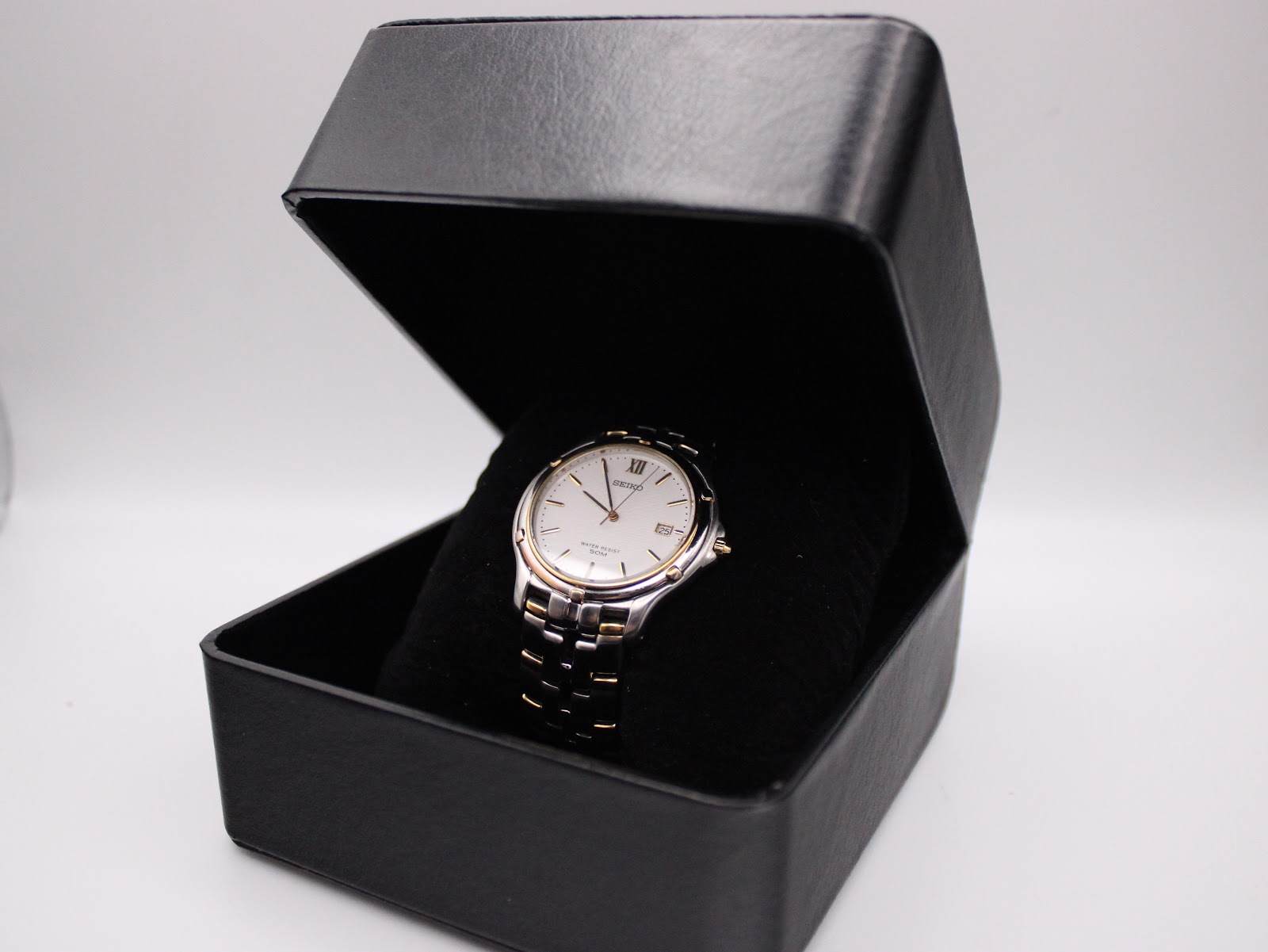 The Seiko watch presented inside a generic black watch box.
