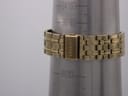 Close-up of the gold-tone steel bracelet clasp with "SEIKO" engraving, on a wrist sizing gauge indicating a circumference of approximately 16.5cm.