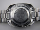 Close-up of the stainless steel case back, showing "SEIKO 6119-7080 STAINLESS STEEL WATER PROOF 871444 JAPAN F" engravings.
