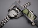 Digital caliper measuring the case diameter of the Seiko watch, showing a precise reading of 36.57mm.