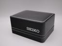 The closed original black Seiko presentation box with "SEIKO" branding on the lid.