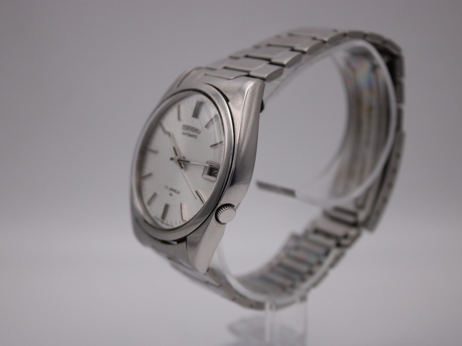 Side profile of the Seiko watch, showing the brushed case and integrated-style steel bracelet.