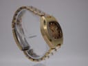 Close-up of the Seiko watch clasp, showing the signed logo and gold plating wear.