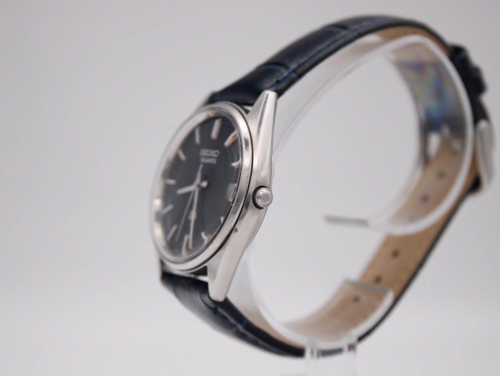 Side profile of the Seiko watch highlighting the slim polished stainless steel case and crown.
