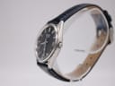 Side profile of the Seiko watch highlighting the slim polished stainless steel case and crown.