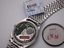 Angled side view of Seiko 8223-8080 showing the slim case, crown, and integrated brick-link stainless steel bracelet.
