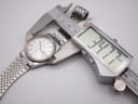 Seiko SQ watch presented on a black velvet cushion inside a sleek black display box.